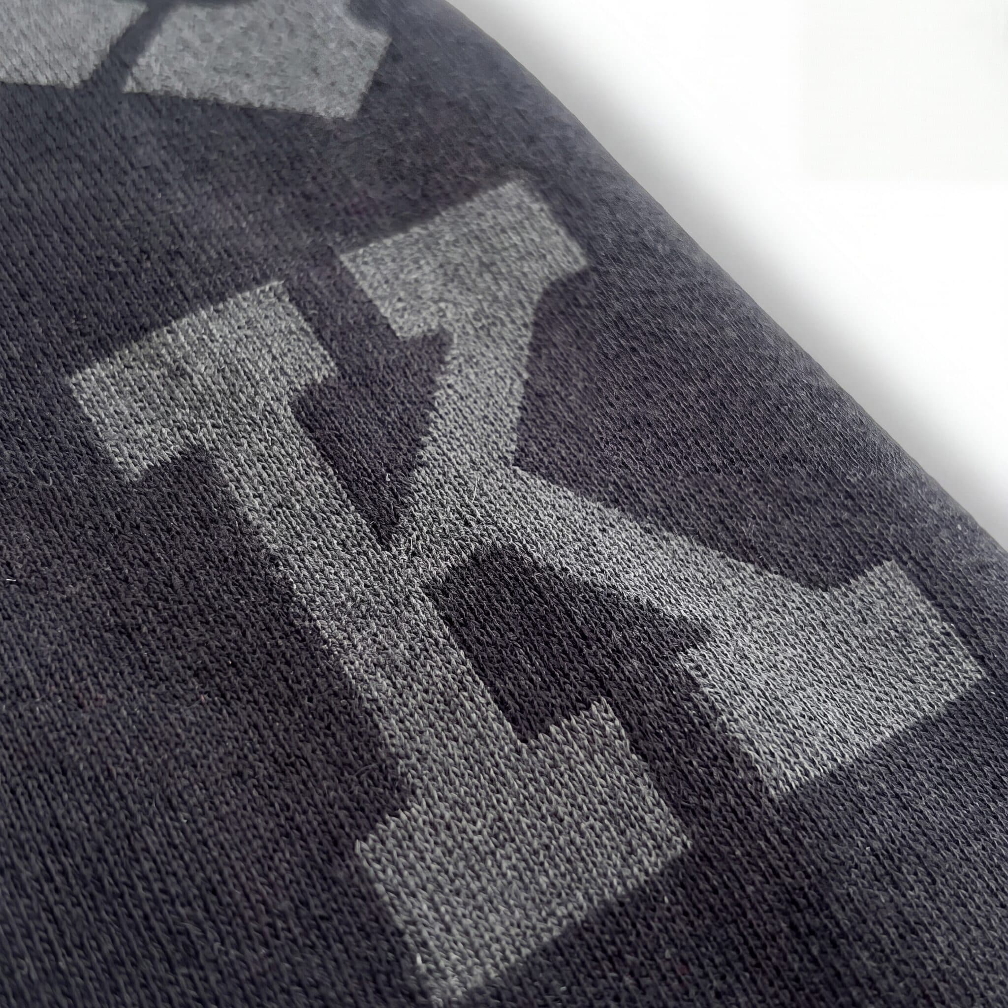 Close-up AI packshot crop of the printed sweatshirt fabric and knit texture